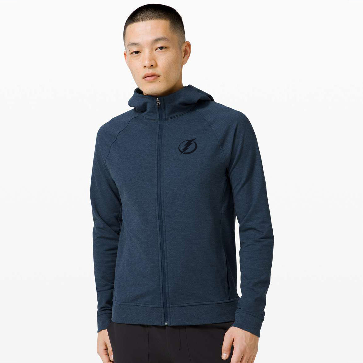 A person wearing a navy blue hoodie with the Tampa Bay Lightning logo on the front.