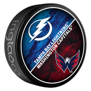 Hockey puck with Tampa Bay Lightning and Washington Capitals logos on a white background